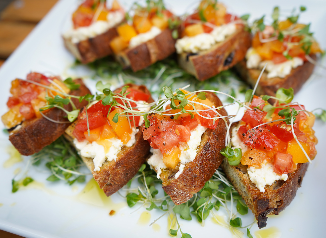 Tomato and ricotta crostini with fresh microgreens