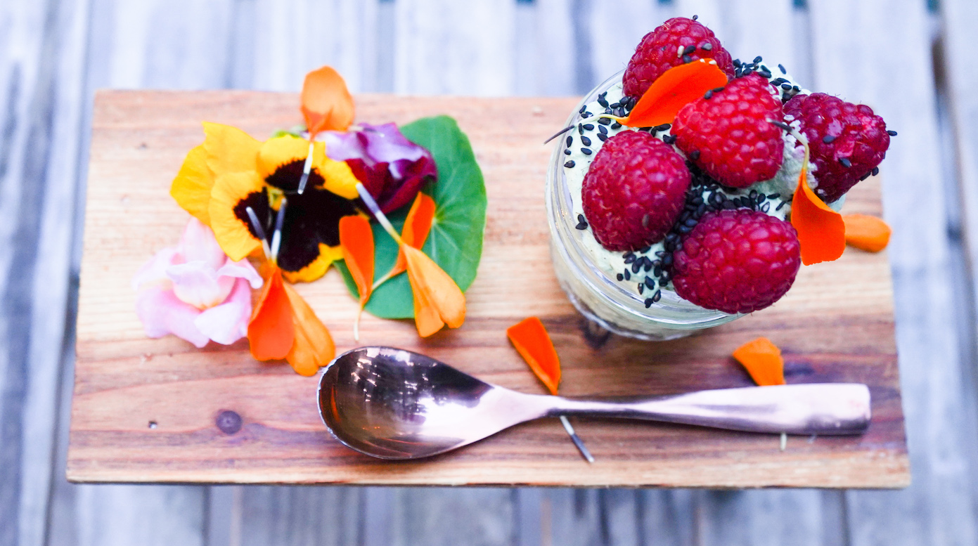 A small raspberry dessert with edible flowers
