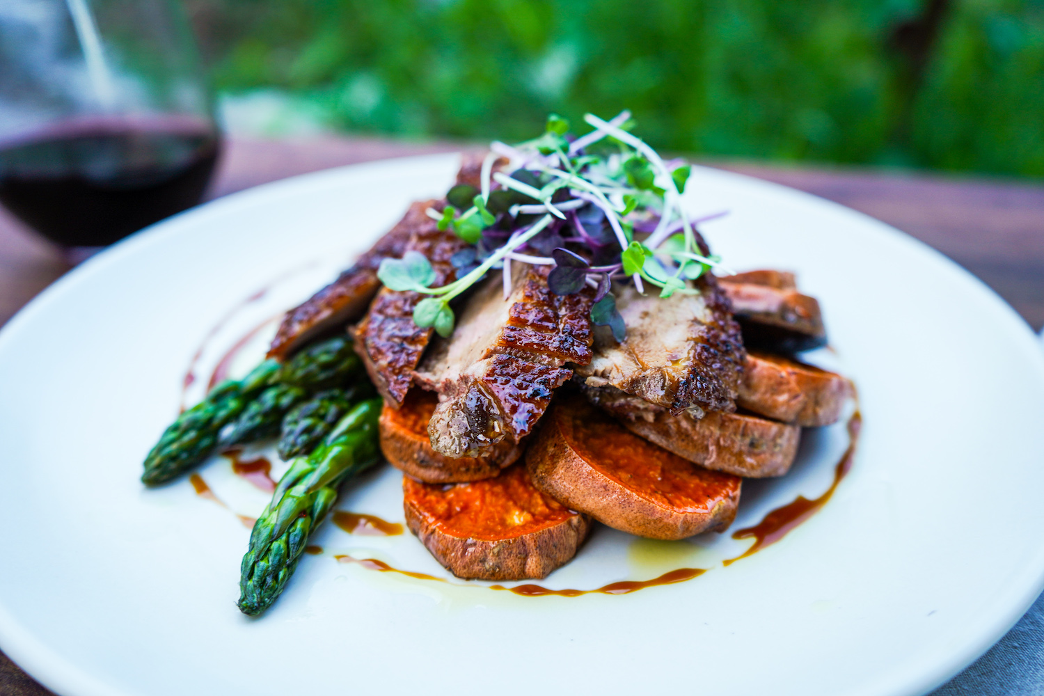 Glazed duck with sweet potato, asparagus, and microgreens